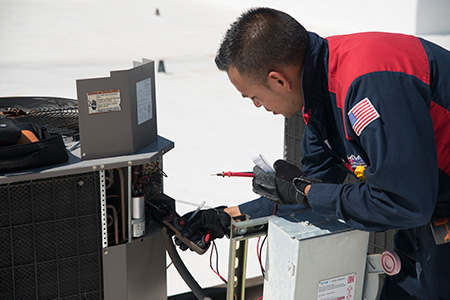 hvac technician repairing ac