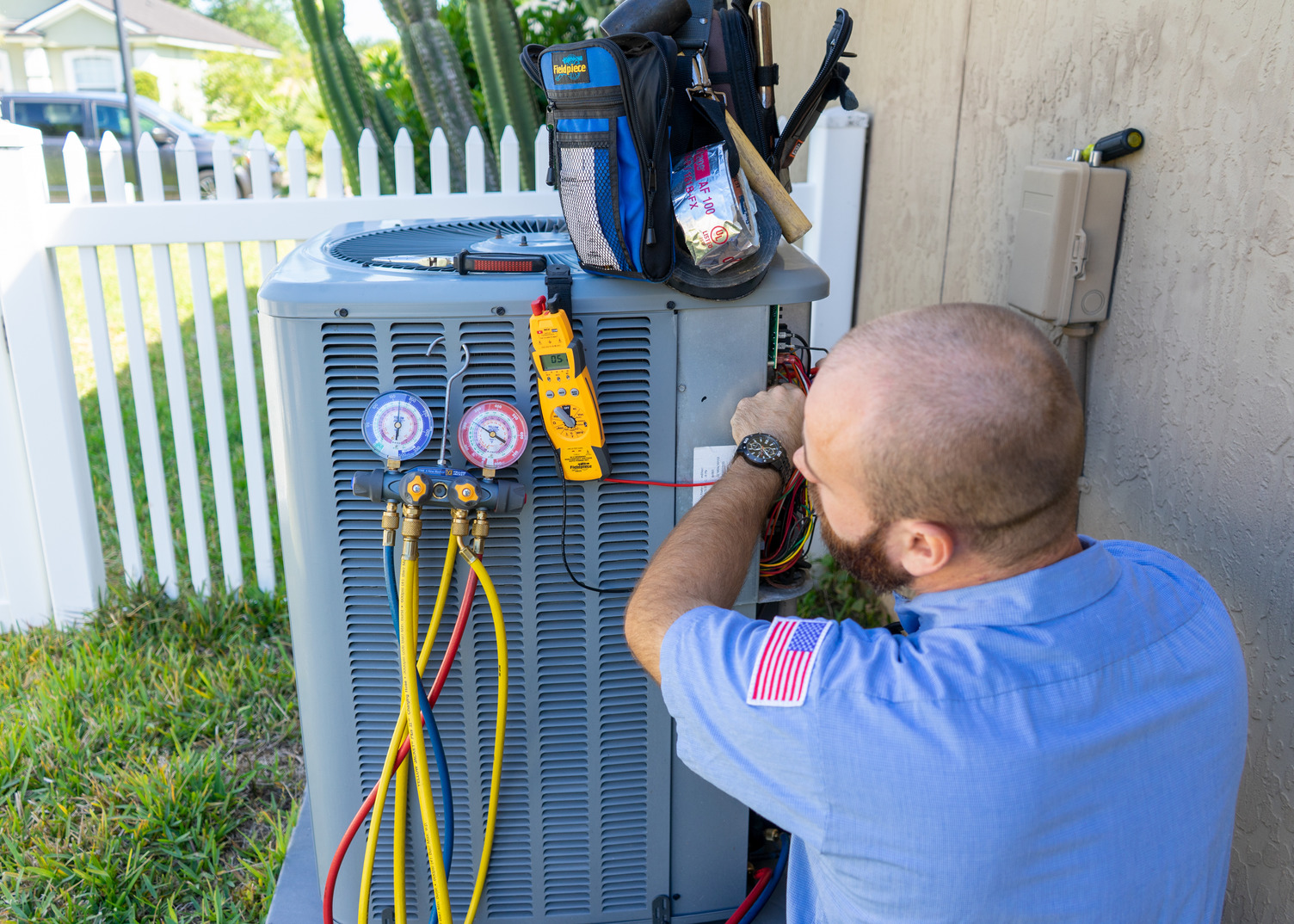 Working with hands on outdoor condenser unit for AC