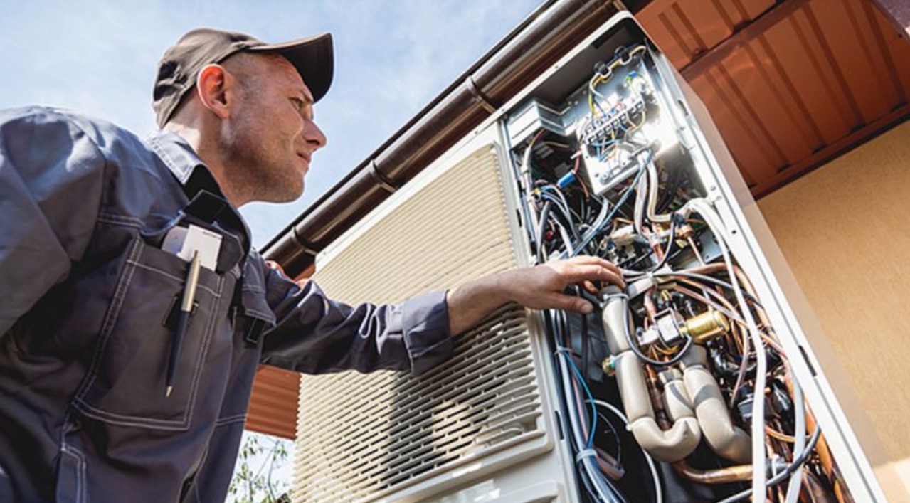 Hvac tech working on outdoor unit
