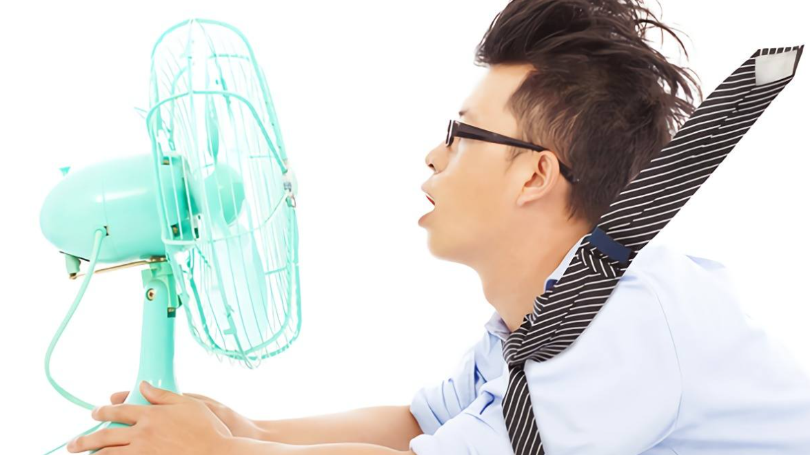man in front of a fan