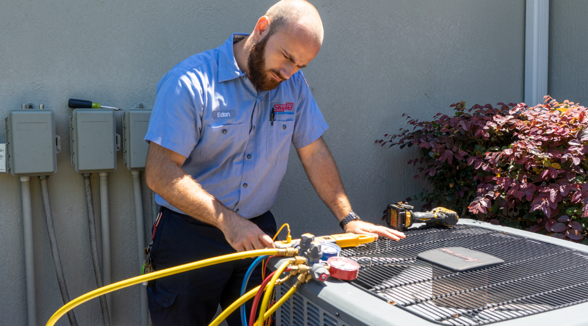 HVAC tech checking gauges