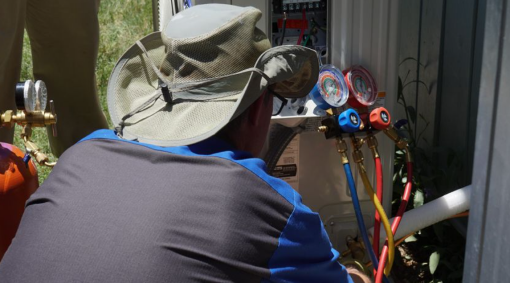instructor working on ac unit