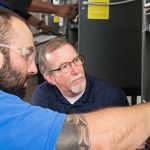 electrician student learning from instructor