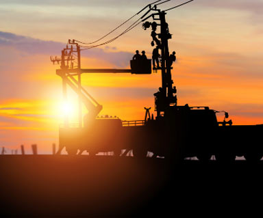 sunset and lineworker