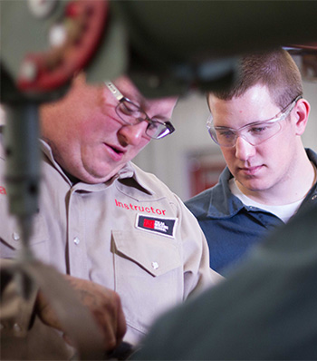 student and teacher at welding school