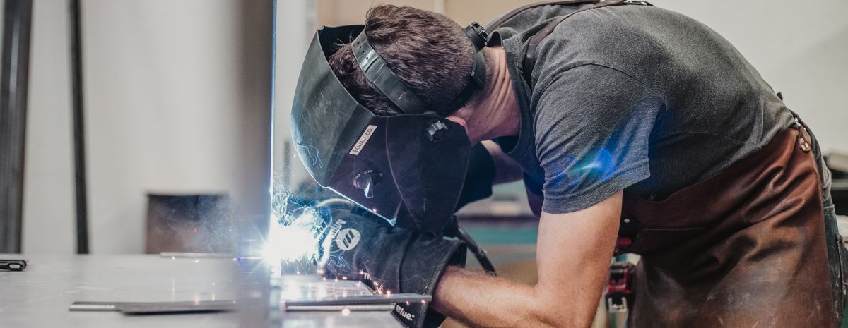 student learning welding at trade school