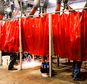 students in welding booths at school