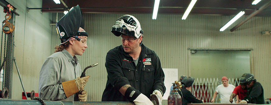 woman learning how to weld