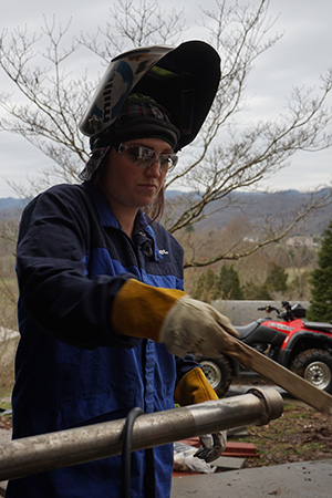 woman welding a pipe