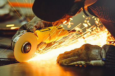 worker using angle grinder